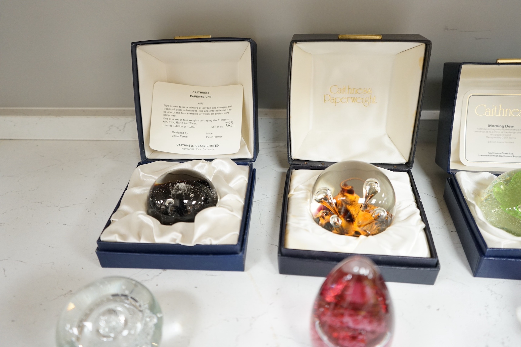 A collection of twenty seven glass paperweights some boxed, to include Caithness and Wedgwood, largest 12cm high. Condition - mostly good